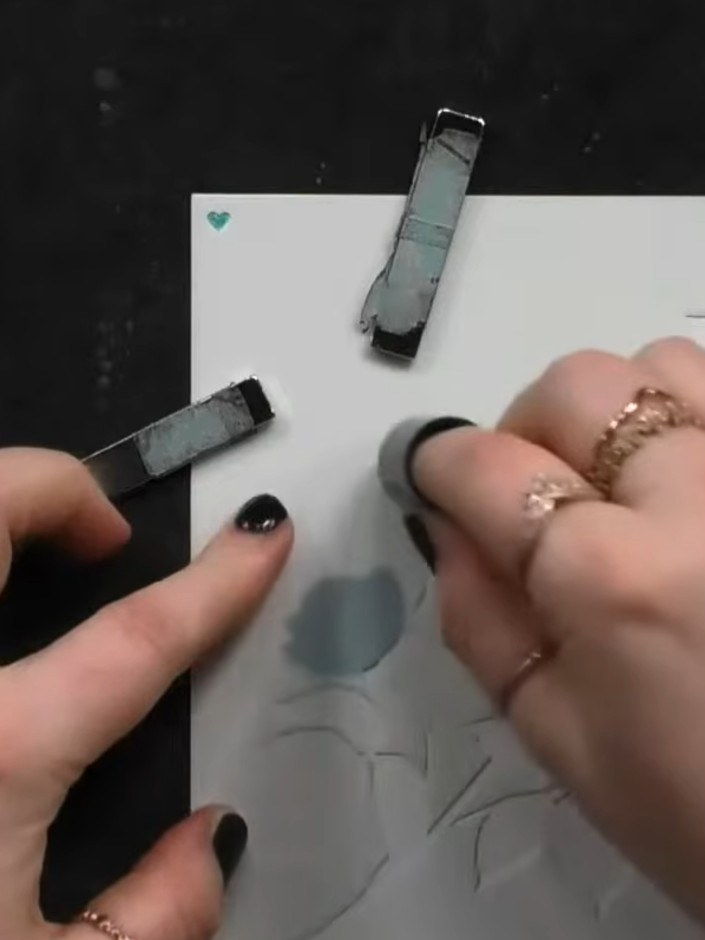 Step 7: Position the final detail stencil over the flower design and blend a darker shade of ink through it to add def