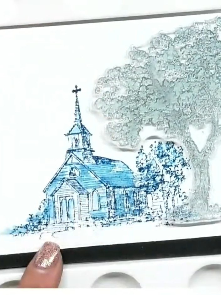 Step 4: Using a wet brush, drag the teal ink outward from the stamped church image to create a watercolour wash effect