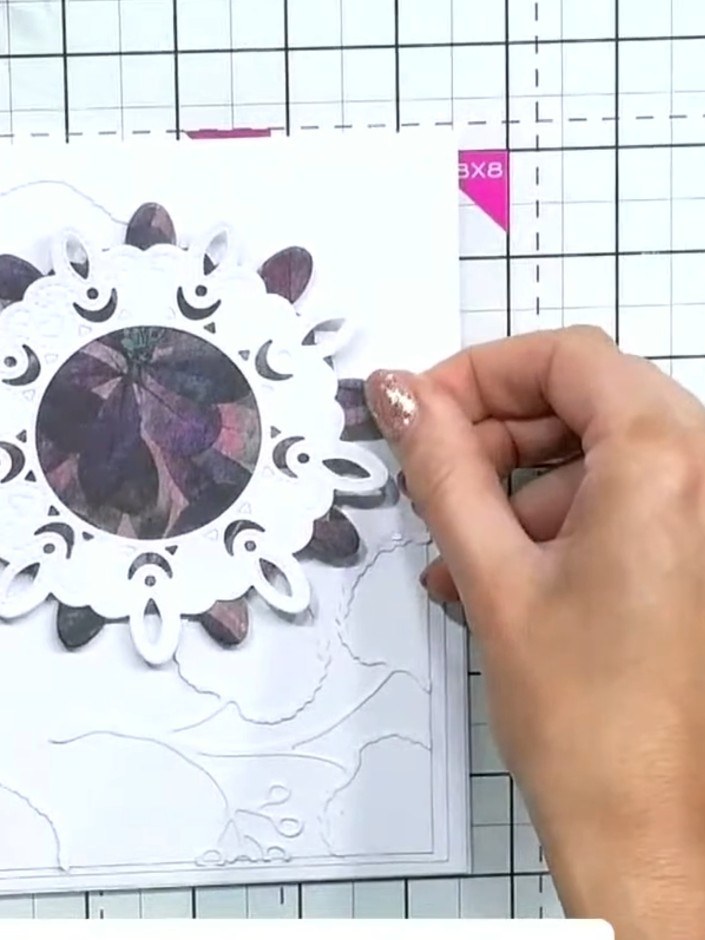 Step 5: Add gems or pearls along the stitch detail line of the decorative die-cut frame to enhance the embellishment. 
