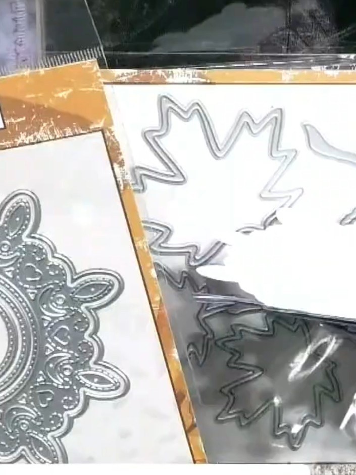 Step 5: Arrange the embossed leaf die-cuts around the central stitched circle, positioning them to create a decorative