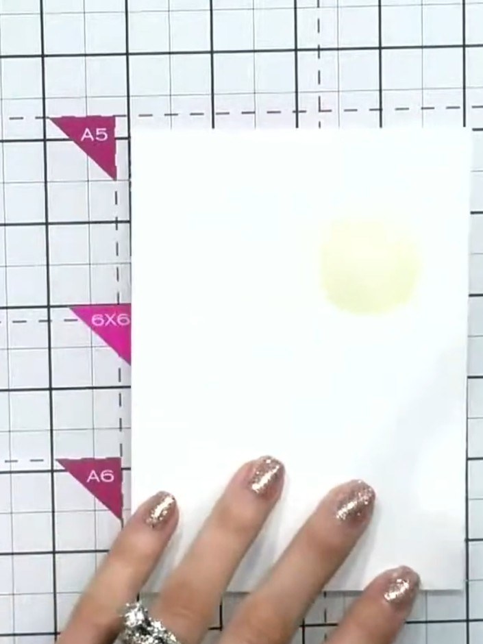 Step 2: Apply blue watercolour ink to the top right area of the wet card using a brush, working the colour into the su
