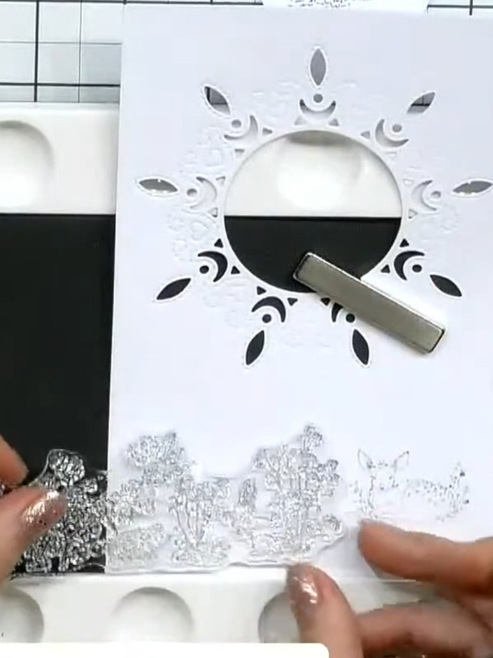 Step 7: Embellish the circular apertures in the die-cut frame by adding diamantés, gems, beads or pearls around the ed