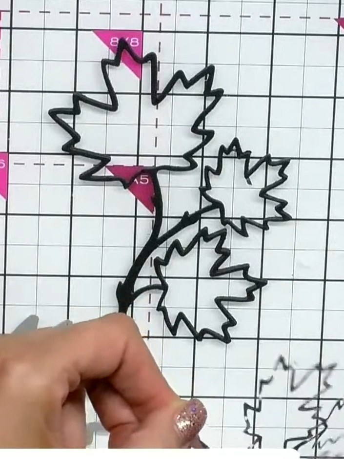Step 3: Stack the three black die-cut leaf pieces together, layering them on top of each other and securing with glue 