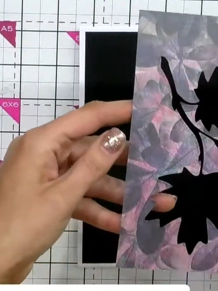 Step 6: Place the patterned die-cut piece back over the top of the black embellishment to hide it completely, creating