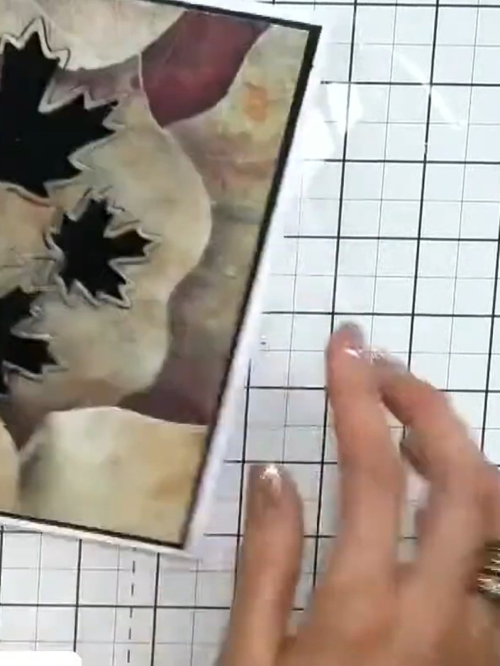 Step 9: View the finished card from the side to see the raised dimensional element created by the layered maple leaves