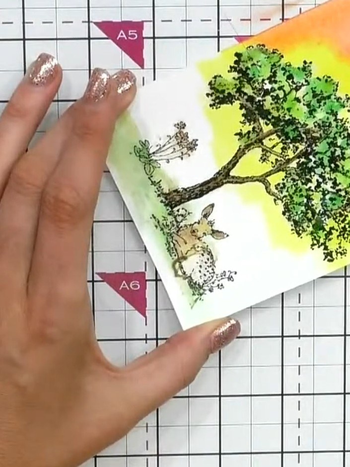 Step 10: Gently rub away the masking fluid with your finger to reveal the protected white areas beneath. The stamped tr