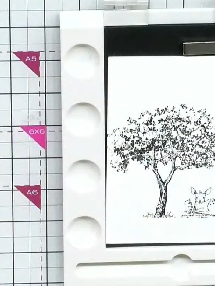 Step 3: Apply masking fluid over the stamped tree and deer image using a fine-pointed applicator bottle, carefully cov