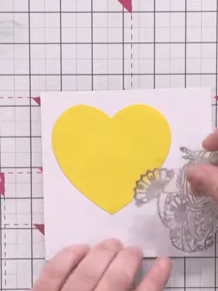 Step 2: Die cut a larger heart shape from scrap paper to use as a mask. Position it roughly where you want your charac