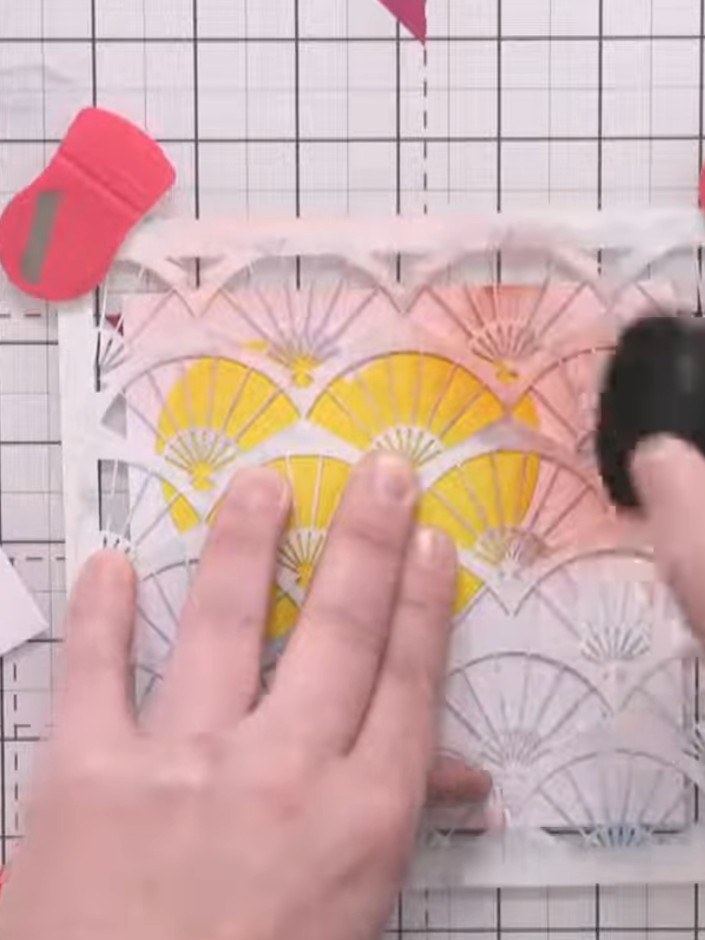 Step 6: Apply the ink pad over the fan stencil, working all the way around the design. Use extra pressure over the hea