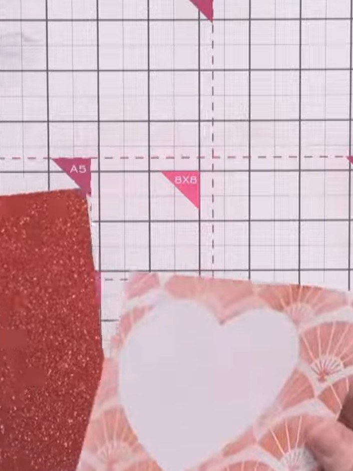 Step 9: Assemble your card by adhering the decorated front panel onto the red top-folding card blank using tape runner