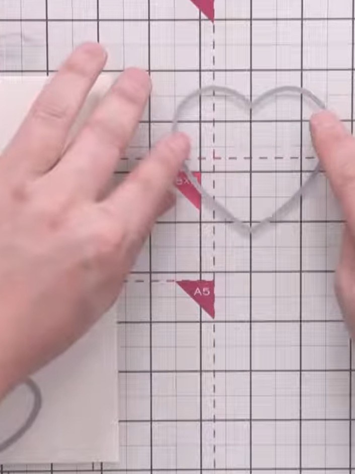Step 3: Arrange nesting heart dies on your gridded cutting mat, using the centre line of each heart to space them even