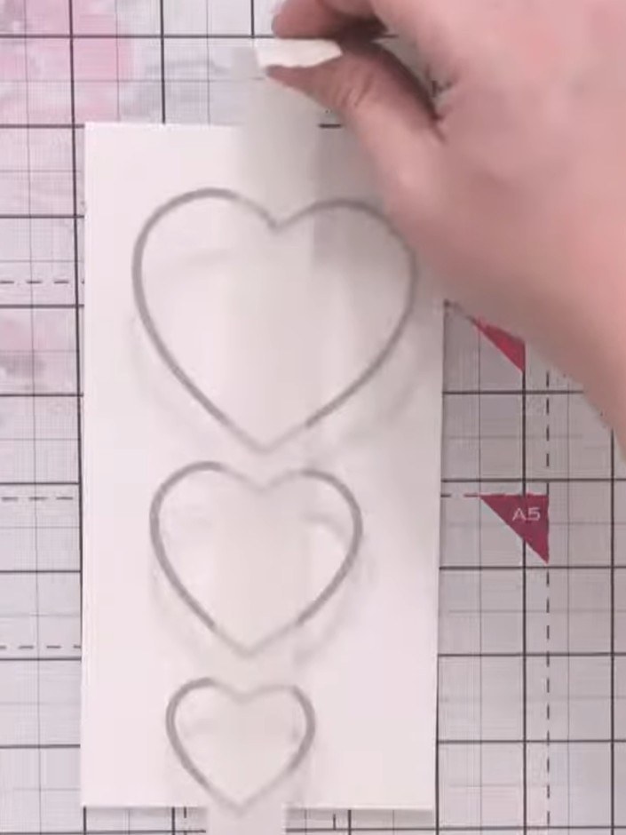 Step 4: Secure the heart dies in position on the card using low-tack tape to prevent them from shifting during die-cut