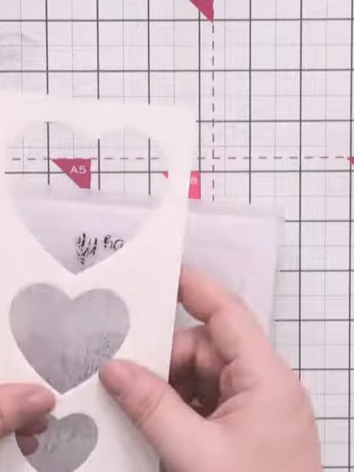 Step 6: Carefully remove the die-cut hearts from the white card panel, leaving them positioned to one side. The hearts