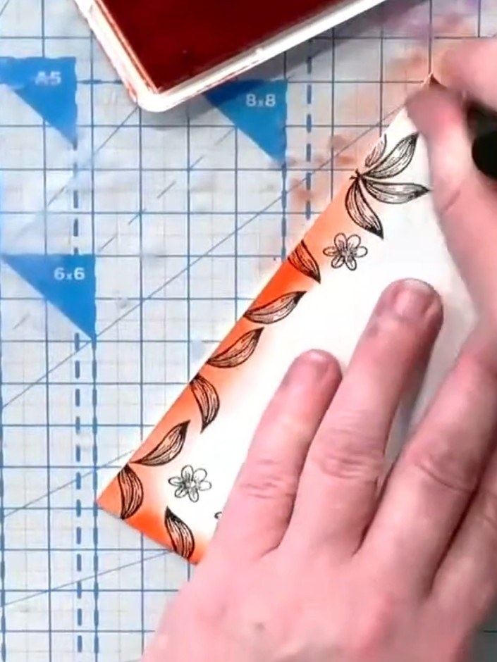 Step 6: Mount the completed stamped and coloured panel onto an orange card base to create a contrasting border frame f