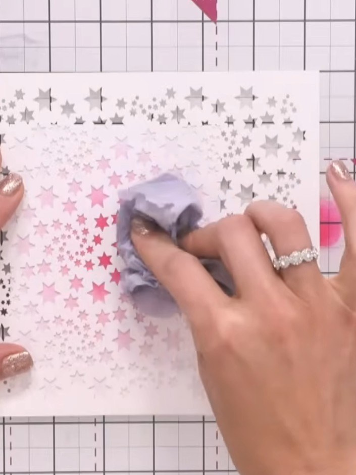 Step 3: Dampen a piece of tissue paper by spraying it with water. Use the damp tissue to lift stars from the centre of