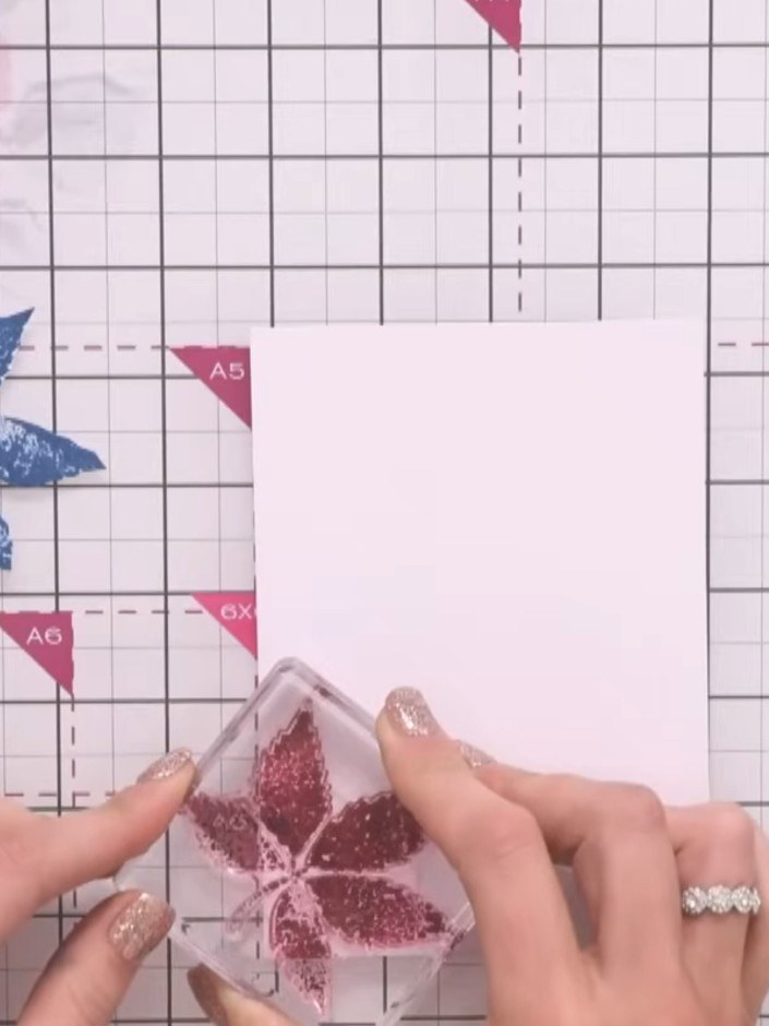 Step 3: Position the leaf mask on your white card stock. Using a blending brush, apply magenta ink around the mask to 