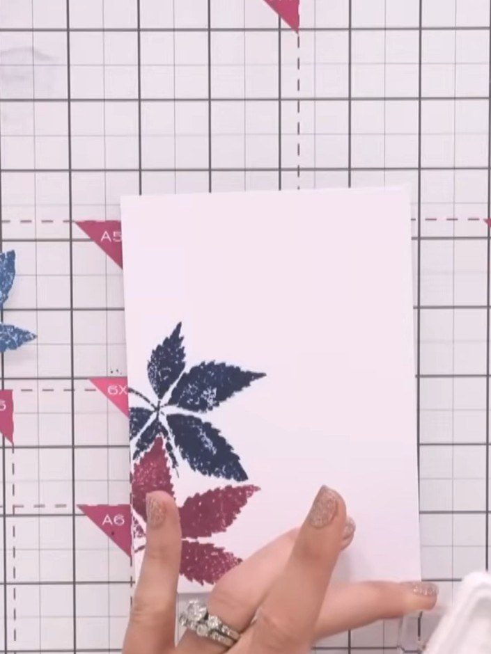 Step 4: Remove the mask from the card. Using the magenta dye ink, blend additional colour onto the leaf design to buil