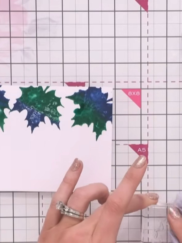 Step 3: Using a contrasting pigment ink colour, lightly tap the stamp onto the glittery leaves to add fine detail. App