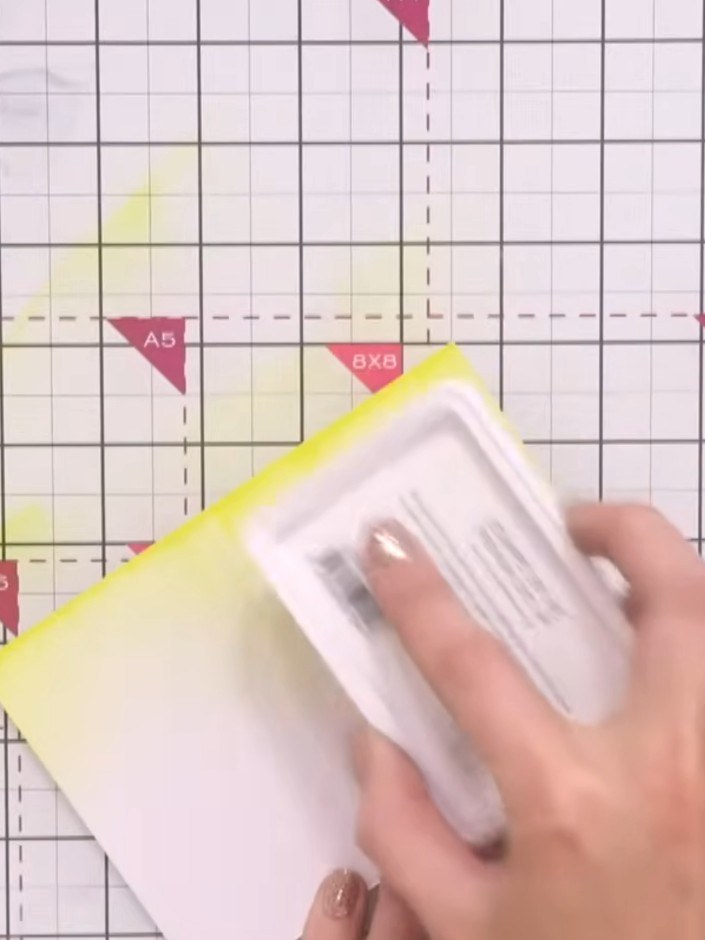Step 1: Create an ink swipe background by dragging yellow ink across your white card stock in horizontal strokes using
