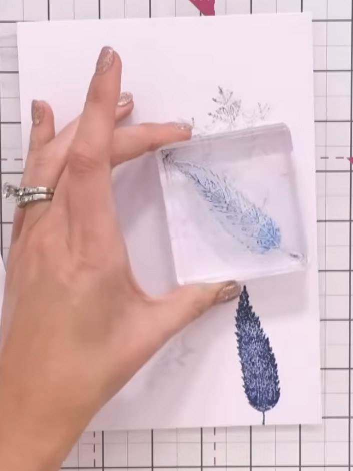 Step 5: Press the stamping block with the combined kiss design onto your prepared ink-swiped background. Use a gentle 