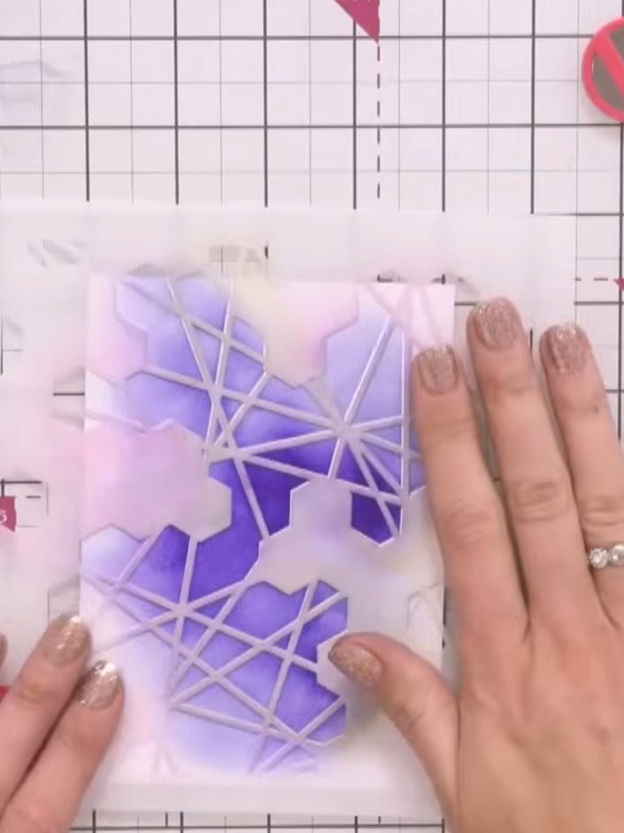 Step 3: Position your honeycomb stencil over the card front. Apply white acrylic paint or ink through the stencil open
