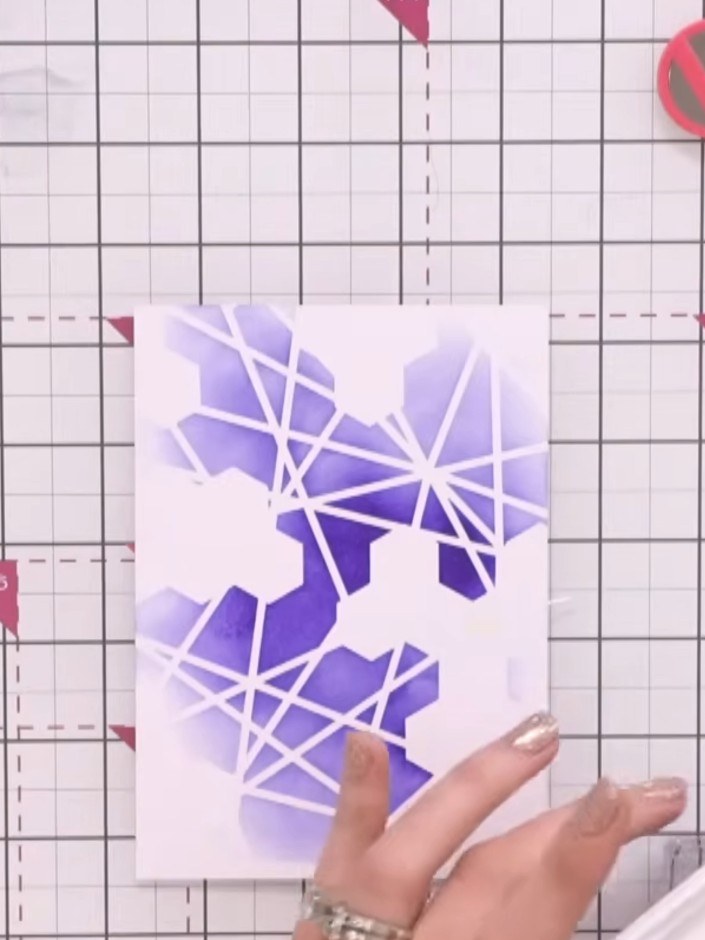 Step 4: Using navy ink, stamp your chosen image over the purple stencilled background to create a tone-on-tone effect.