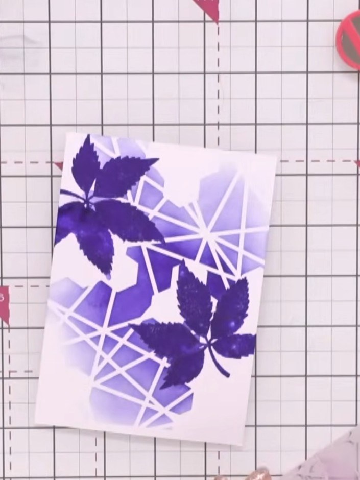 Step 5: Add white embellishments or details over the stamped design to enhance the contrast and tie the purple and whi