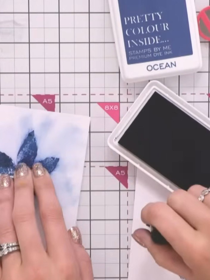 Step 3: Stamp your chosen image into the masked area using Ocean blue ink. Press the stamp firmly onto the ink pad, th