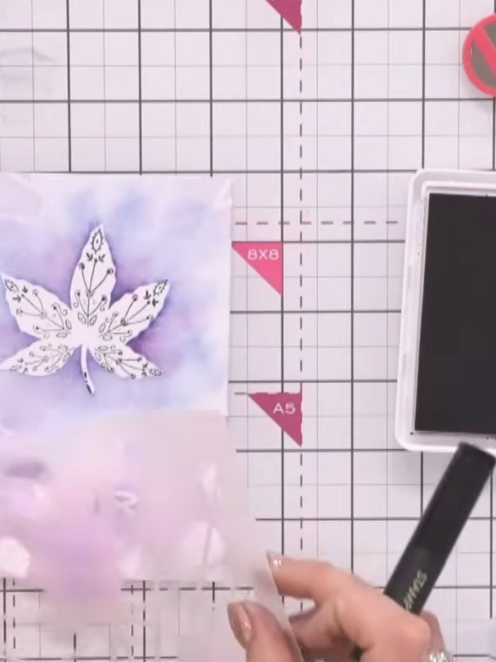Step 6: Use white ink and a small stamp to add decorative details around the leaf and background. Fill any gaps in the