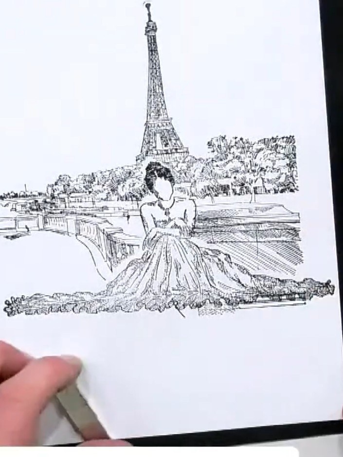 Step 4: Carefully remove the masking tape from the stamped image to reveal the seamlessly layered Paris scene with the