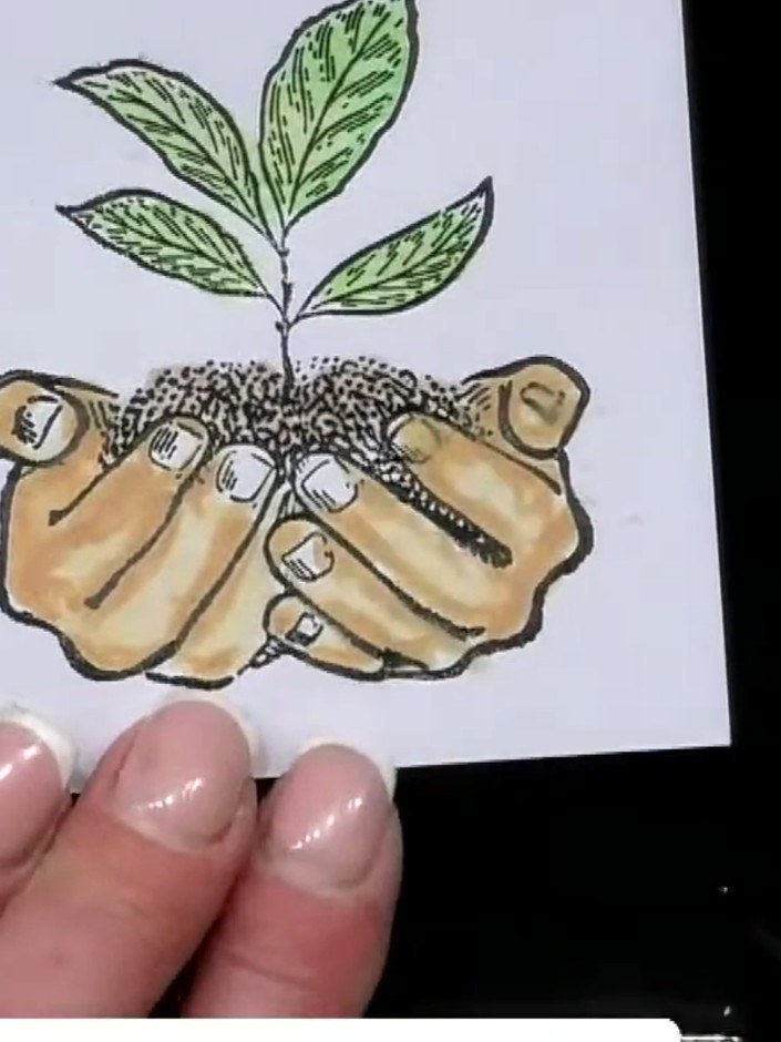 Step 8: Add your chosen sentiment stamp to the card. Position it below the hands and plant image. Stamp carefully to c