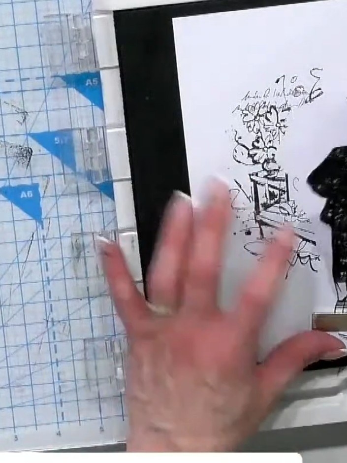 Step 4: Stamp the adventure design or additional elements over the watercoloured background to add layering and depth.