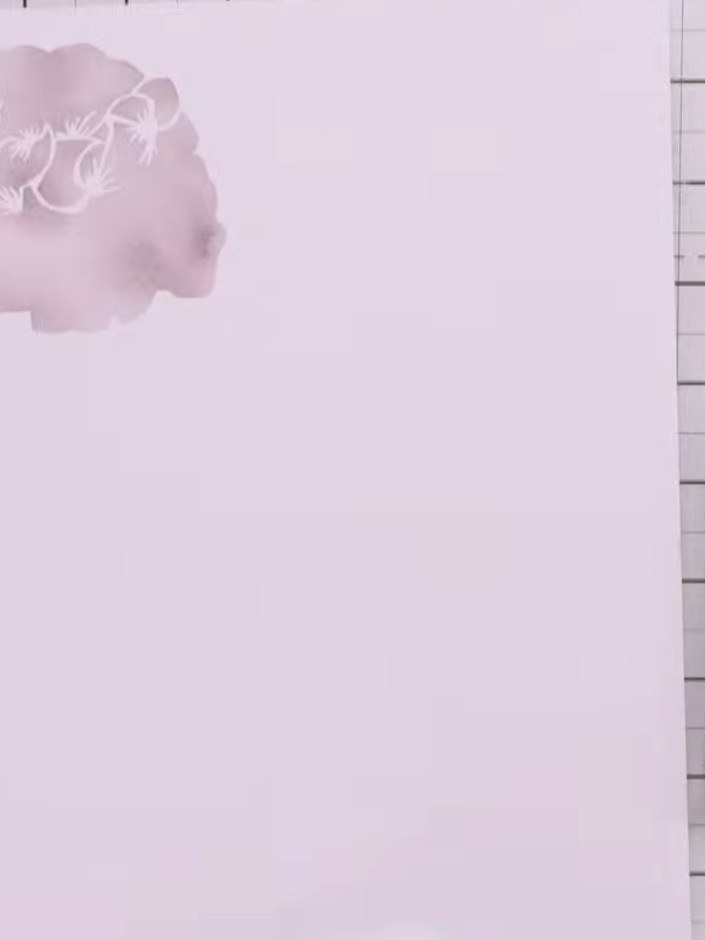 Step 3: Position the second stencil over the stamped flower image, aligning it carefully. Apply the next layer of pink