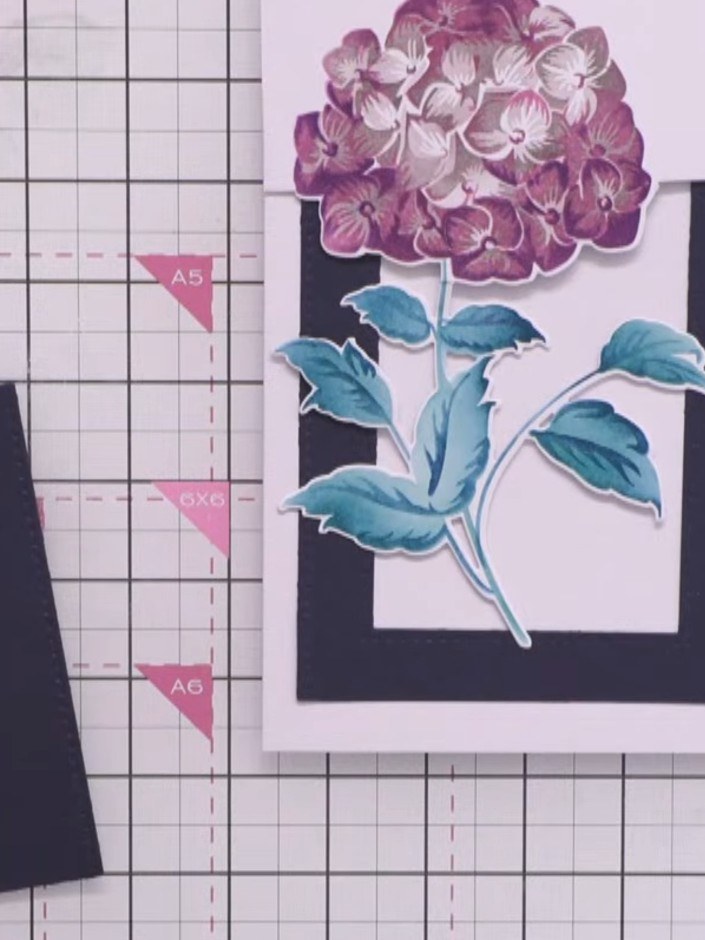 Step 7: Adhere the largest black die-cut frame to your card base. Layer the smaller black die-cut frame on top to crea