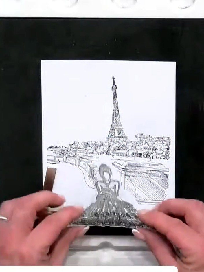 Step 5: Carefully remove the mask from the stamped image to reveal the figure positioned in front of the Paris skyline