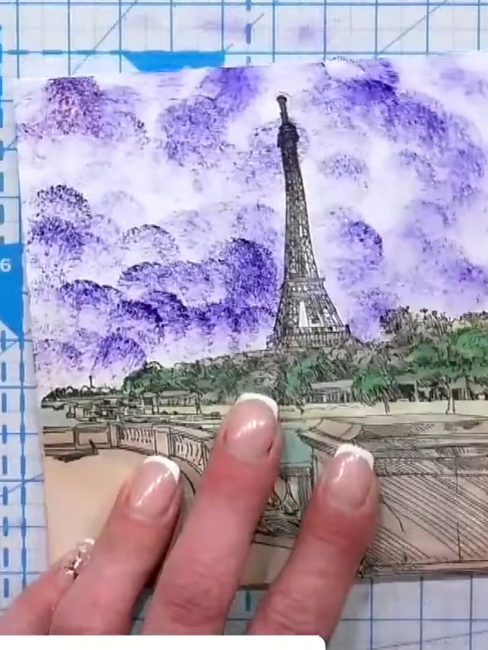 Step 5: Stamp the prepared Eiffel Tower stamp onto white cardstock, pressing firmly and evenly to transfer all the lay