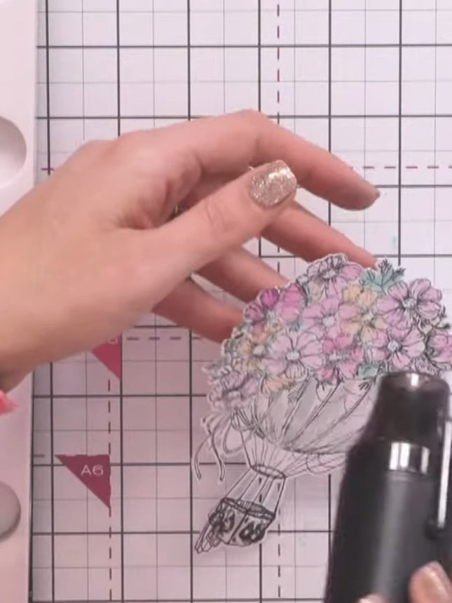 Step 13: Use a white gel pen to add highlights to the water area at the bottom of the hot air balloon image, creating s