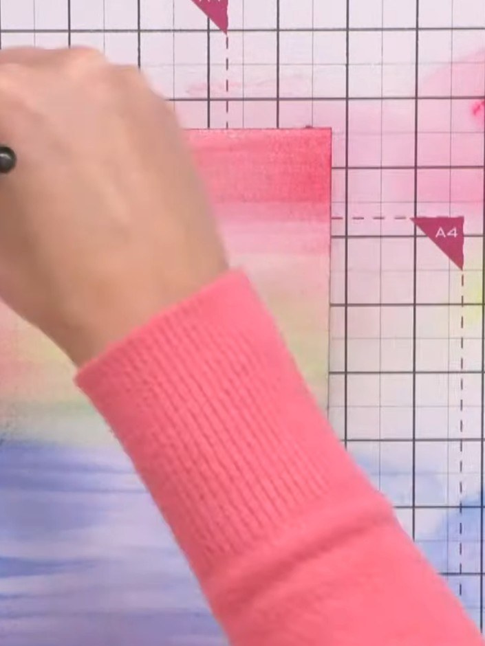 Step 4: Spray the card again with water. Add a third colour such as pink or purple to the upper portion to enhance the