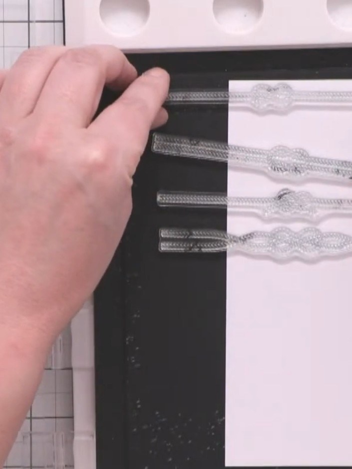 Step 2: Remove the rope and knot stamps from the carrier sheet and arrange them in a single column down one side of yo