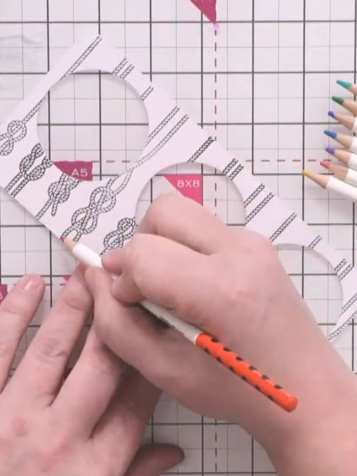 Step 5: Colour each rope design using oil coloured pencils in bright colours. Use a different colour for each rope sec