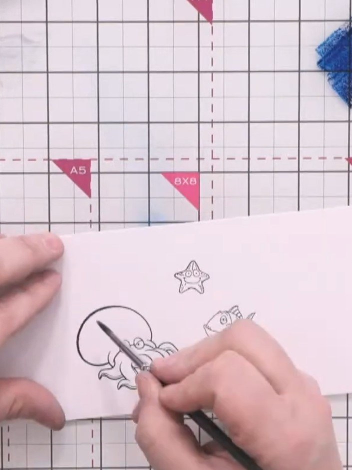 Step 11: Watercolour each stamped character using Ocean and Tiffany inks with a wet brush. Pull the colour from the cen