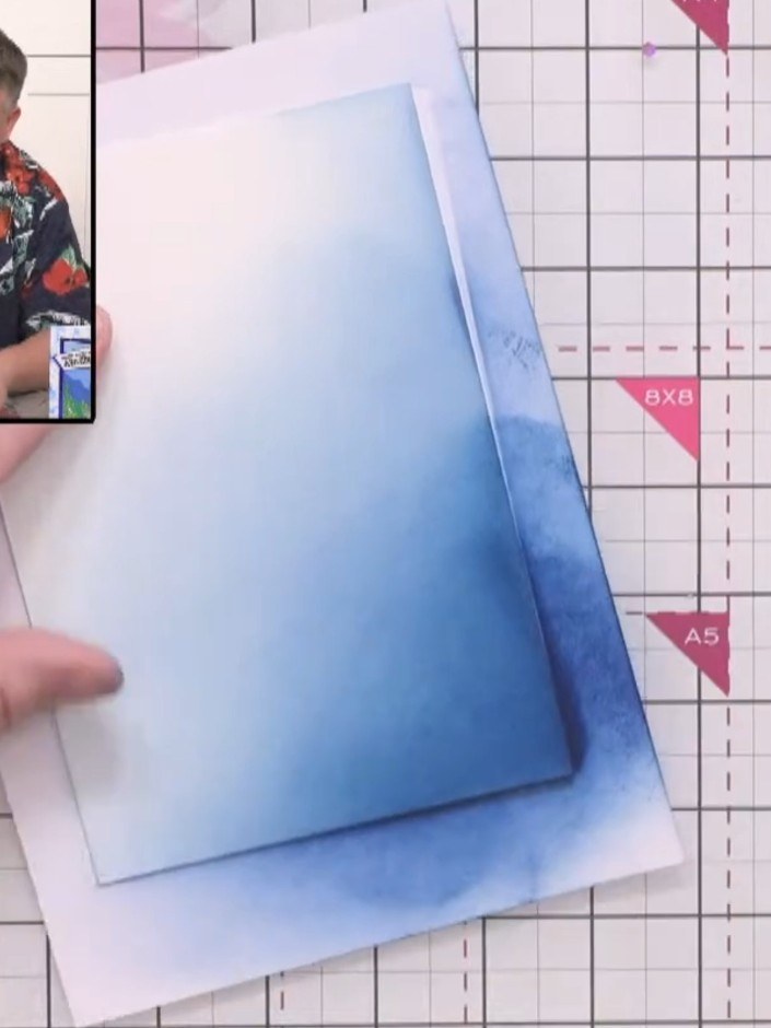 Step 5: Apply the Tiffany ink pad to the same corner area of the card, blending over the Ocean ink to deepen the colou