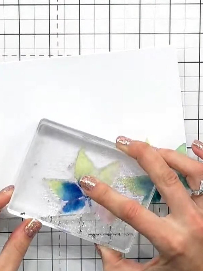 Step 4: Press the wet stamp firmly onto your cardstock to transfer the watercoloured image. Lift the stamp carefully t