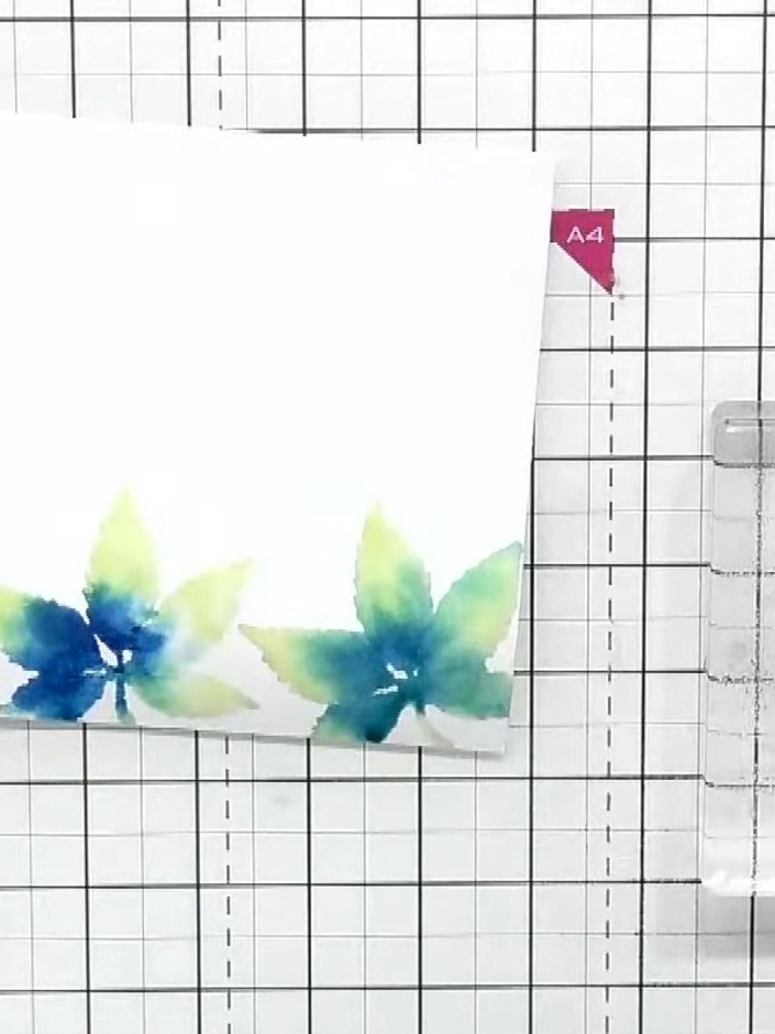 Step 5: Carefully lift off the stamp to reveal the watercoloured leaf border on your white card. The design should sho