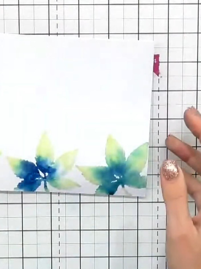 Step 6: Using black sticky ink, stamp the detail overlay portion of the leaf stamp over the watercoloured leaves to ad