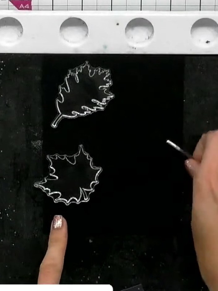 Step 1: Place your black card stock on the Eureka watercolour tablet. Position the leaf stamps from the Love Beyond Wo