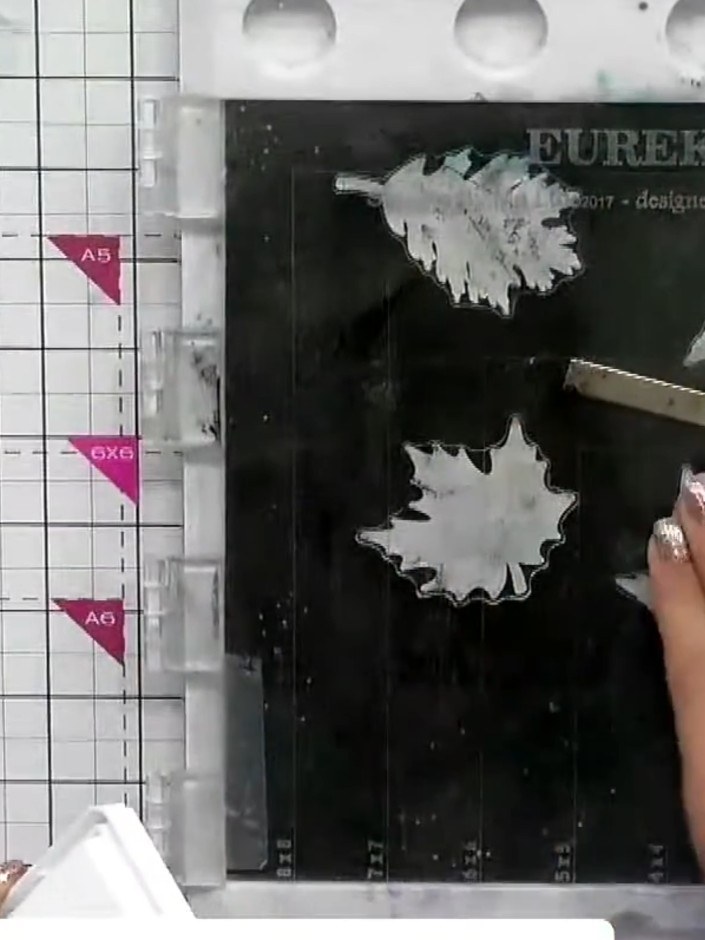 Step 5: Place the detailed leaf stamps onto the Eureka 101 stamping platform. Ink the stamps with your chosen watercol