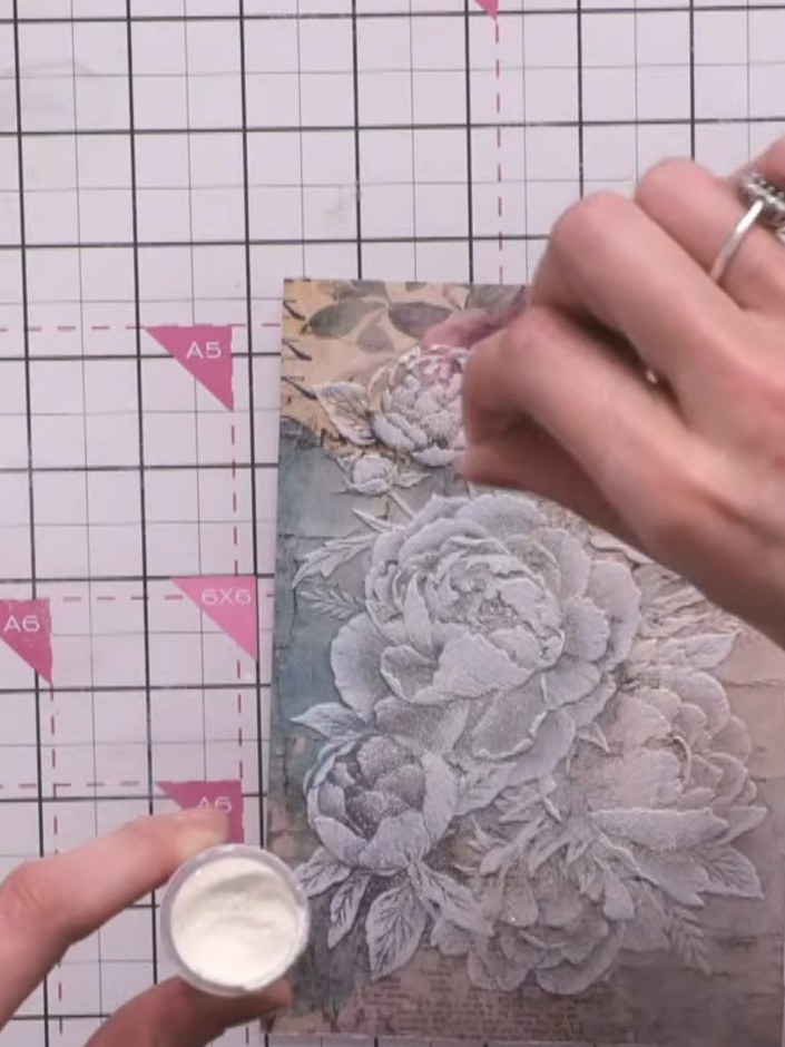Step 4: Tap off any excess embossing powder onto a piece of card to catch it for reuse. Heat set the powder using an e