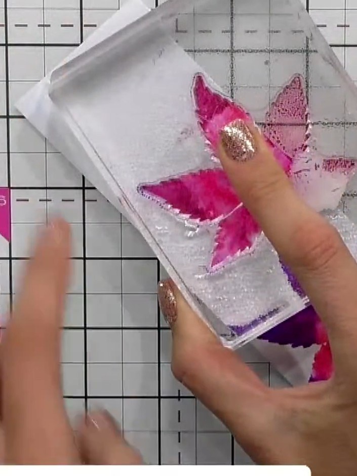 Step 6: Repeat the stamping process with additional colours, positioning the flower stamp in different areas of the cl