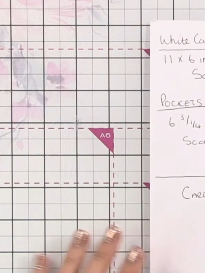 Step 1: Cut a piece of white card to 11 by 6 inches. Score the card at 5 inches and 6 inches to create the book base.